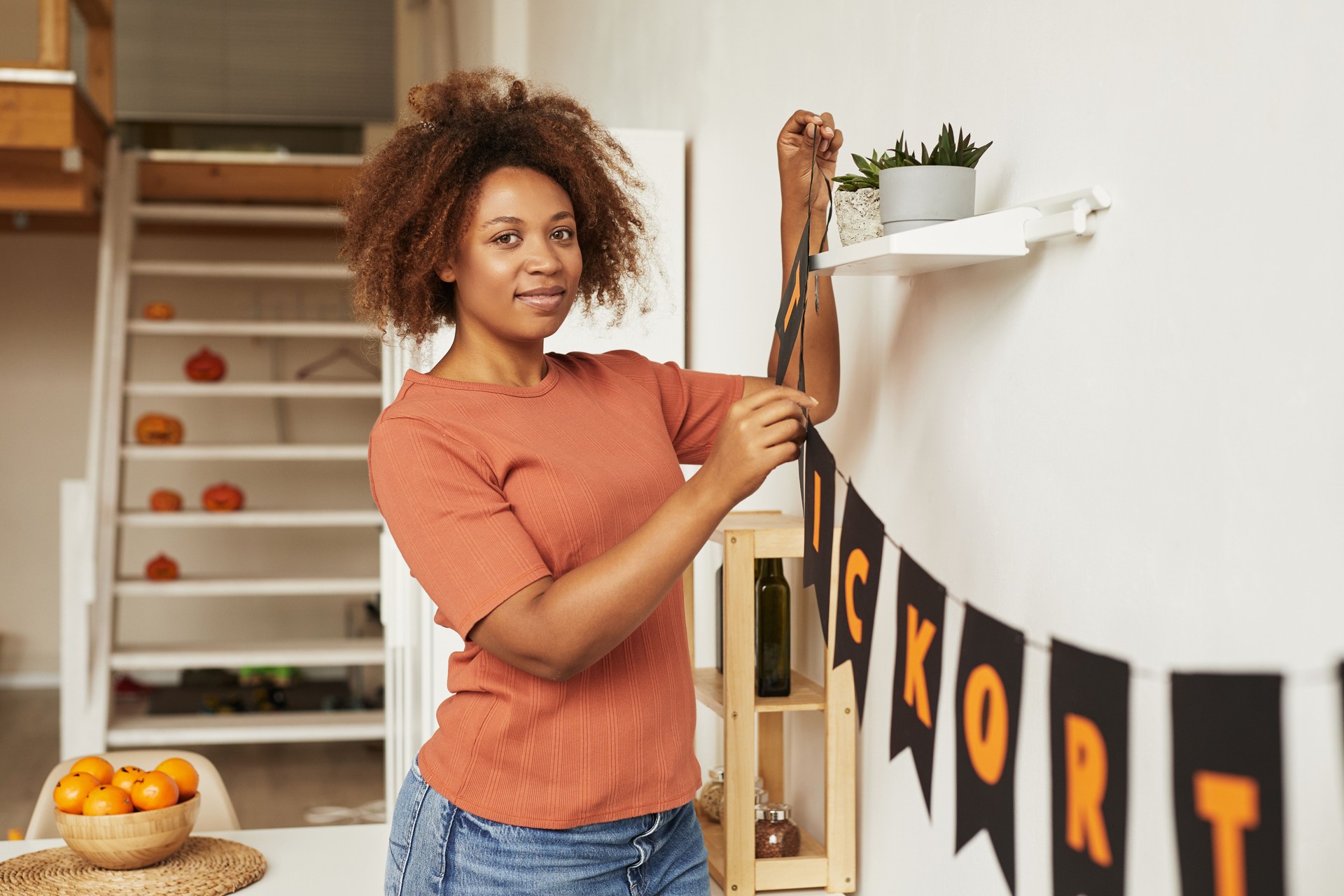 Woman Decorating Home For Halloween